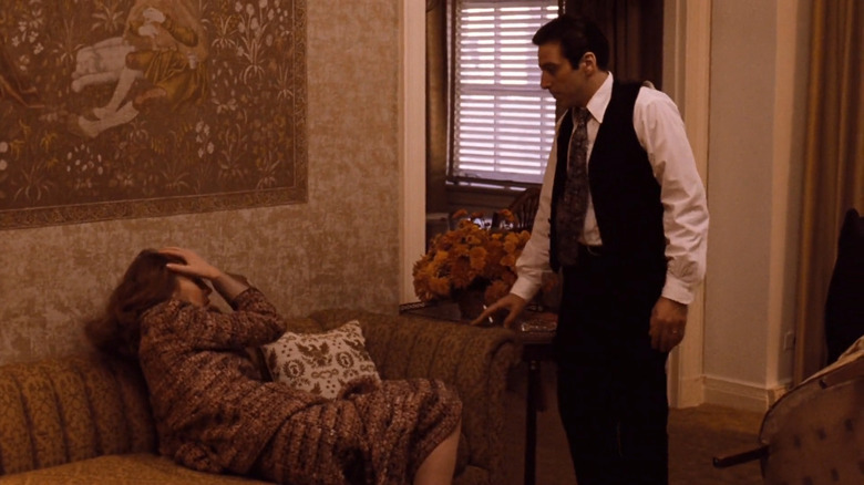 Michael standing over Kay