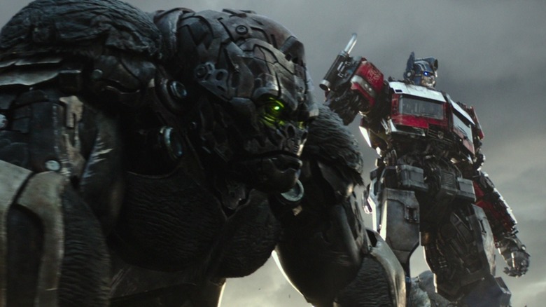 Optimus Prime standing with Optimus Primal