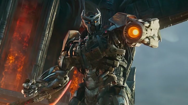Scourge aims his arm cannon on Unicron's exterior