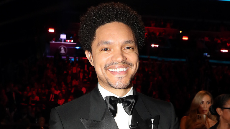 Trevor Noah grinning in a tuxedo