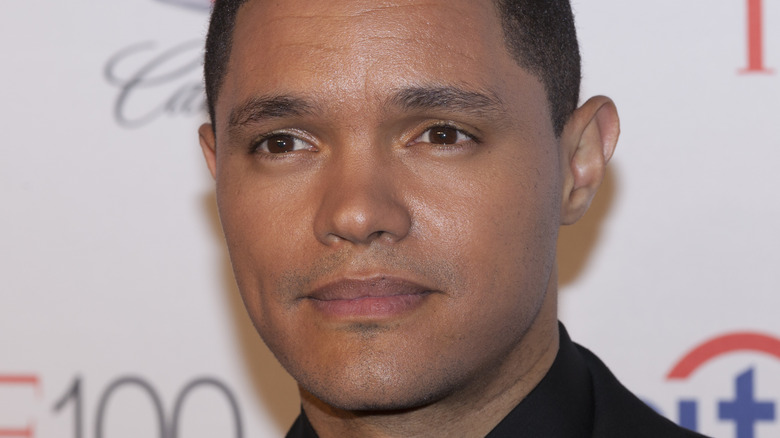 Trevor Noah looking stoic at a movie premiere