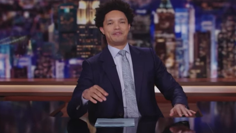 Trevor Noah at Daily Show desk