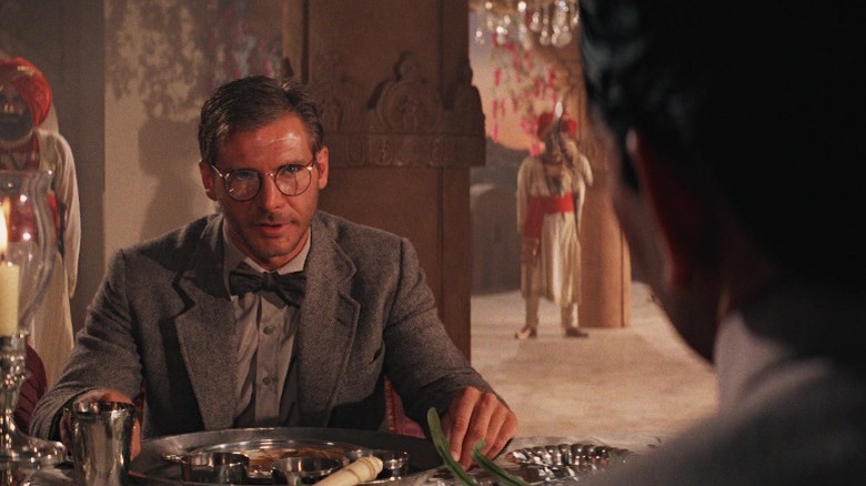 Indiana Jones sitting at palace dinner table in Indiana Jones and the Temple of Doom (1984)