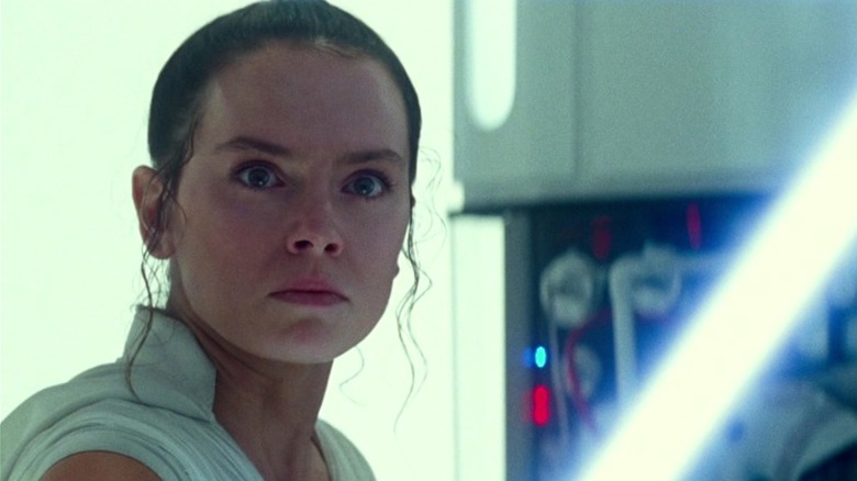 Rey holding a blue lightsaber in Star Wars: The Rise of Skywalker (2019)