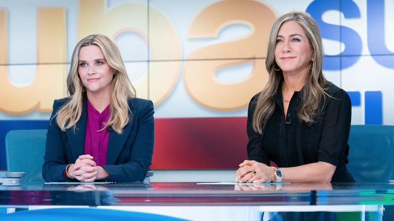 Reese Witherspoon and Jennifer Aniston at the news desk on The Morning Show