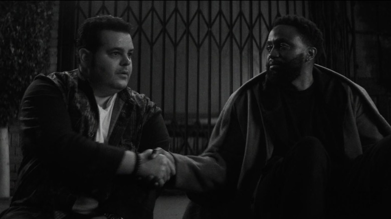Josh Gad and Doorman shake hands in "Wonder Man" (2026)