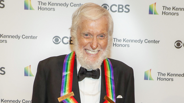 Dick Van Dyke smiling wearing a rainbow ribbon from being honored at The Kennedy Center