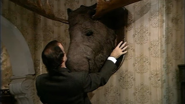 Basil Fawlty gawks at moose head