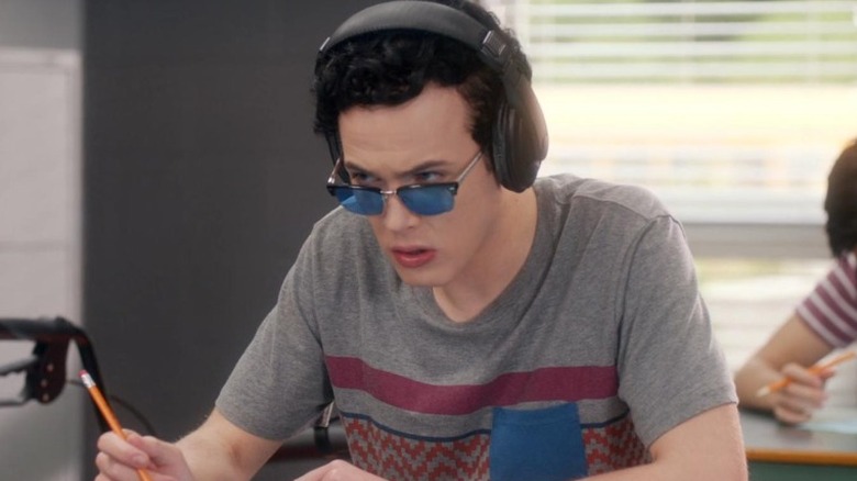 Tristan Milligan sitting at his desk wearing sunglasses