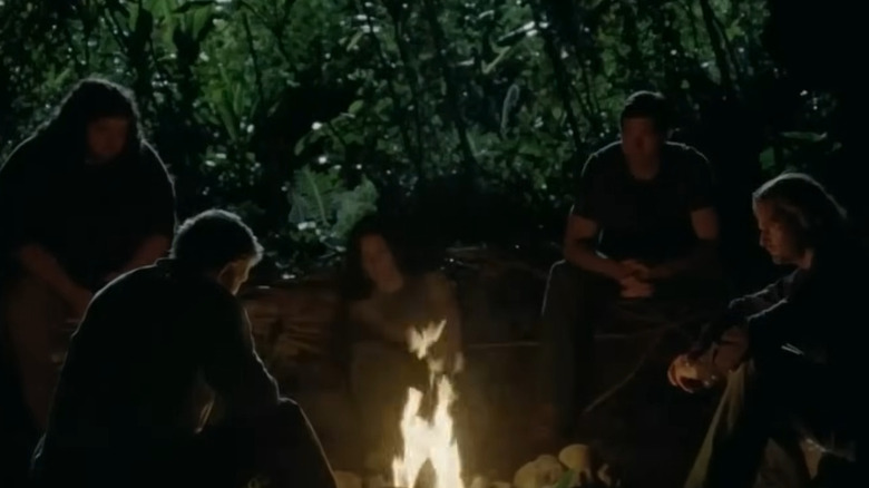 "Lost" survivors huddled around campfire