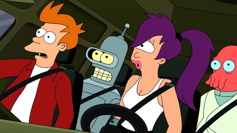 Fry, Leela, Bender and Zoidberg sit behind the wheel of a car while wearing seatbelts in "Futurama"