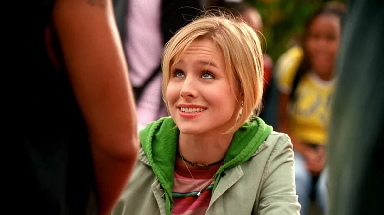 Veronica Mars looks up and smiles awkwardly while wearing a green hoodie in "Veronica Mars"