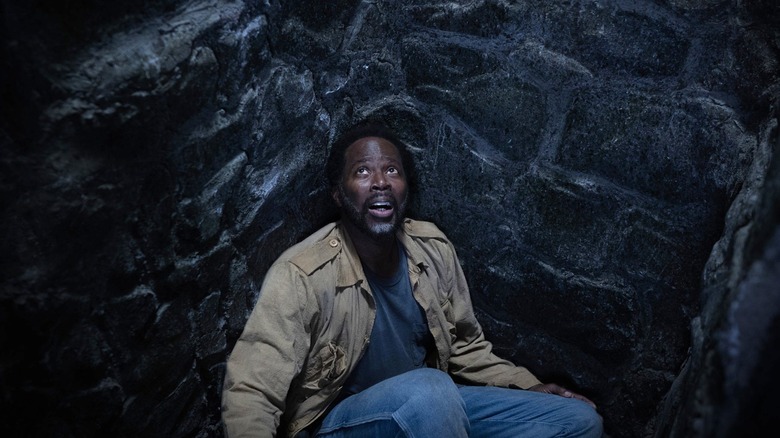 Boyd is trapped in a pit and looks up.