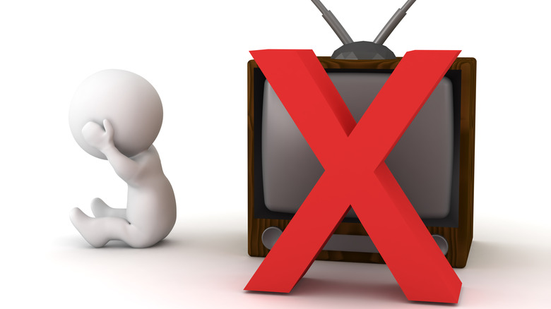 Cartoon figure covering ears beside TV