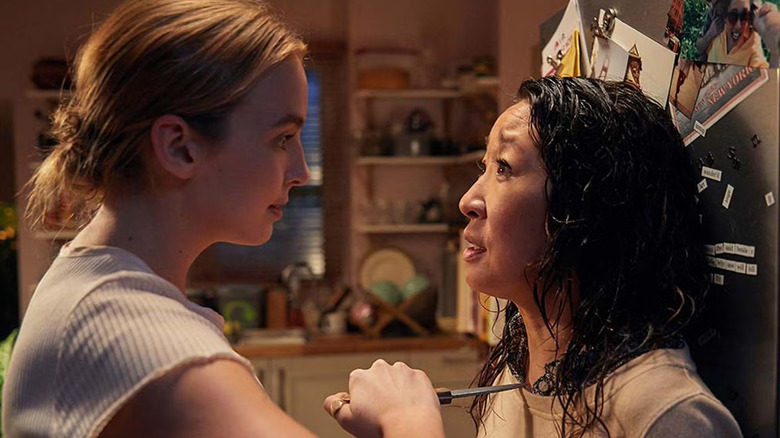 Villanelle holding a knife to Eve's throat in her kitchen on Killing Eve