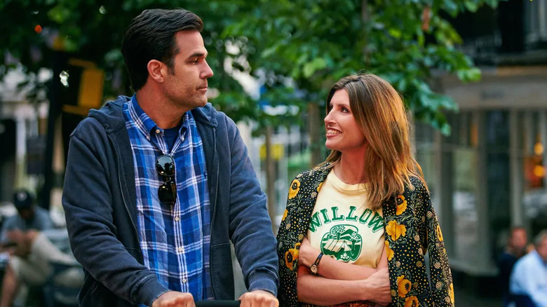 Rob and Sharon outside pushing a stroller and looking at each other on Catastrophe