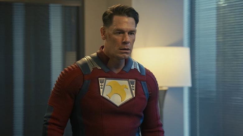 Peacemaker looking stunned in his uniform in Peacemaker
