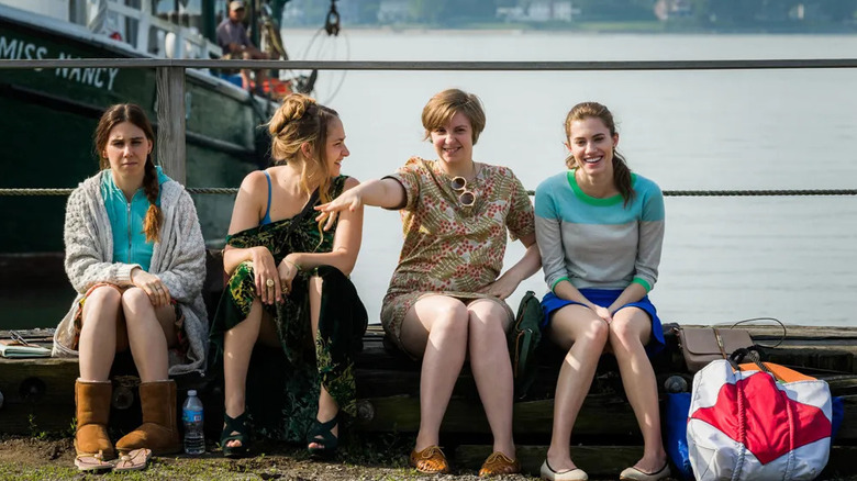 Shoshanna Jessa Hannah and Marnie sitting by a dock on Girls