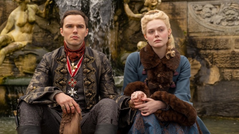 Peter and Catherine sitting together and holding hands on The Great