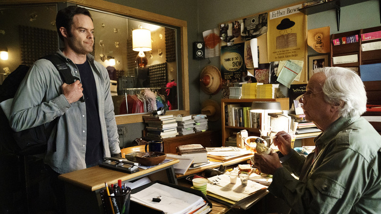 Barry Berkman standing in Gene Cousineau's office holding backpack while Gene paints animal figurine