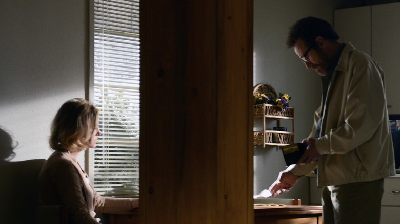 Walter White in Skyler's kitchen putting lottery ticket on table