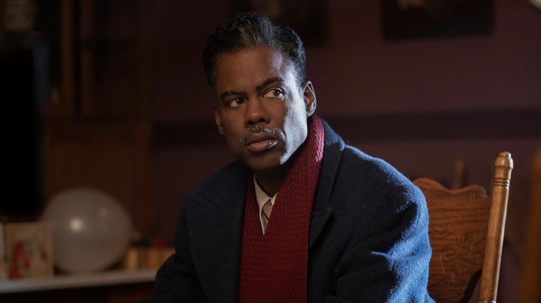 Loy Cannon sitting at office desk scowling