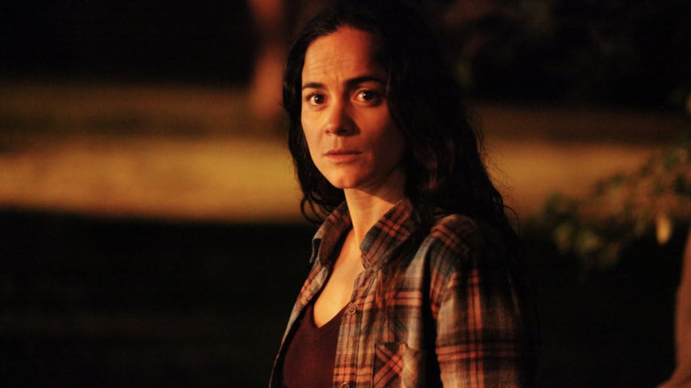 Teresa Mendoza standing outside at night in flannel over black v-neck t-shirt