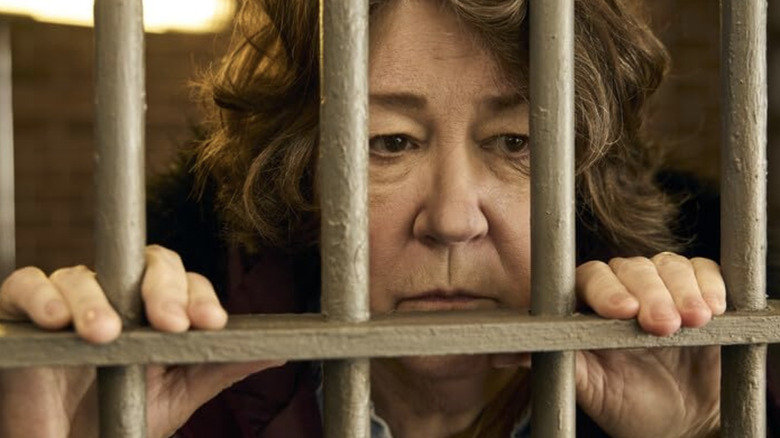 The Sticky Ruth Landry scowling through bars of jail cell