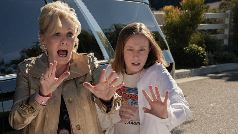 Deborah and Ava in front of a car screaming on Hacks