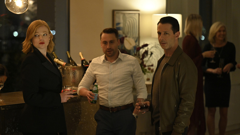 Shiv Roman and Kendall looking at someone at a party on Succession