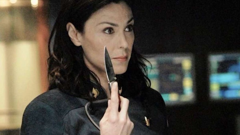 Admiral Cain holds a knife