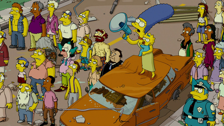 Marge on top of a car with a bullhorn
