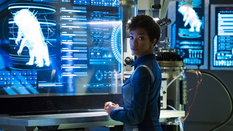 Burnham looks at a tardigrade on screen