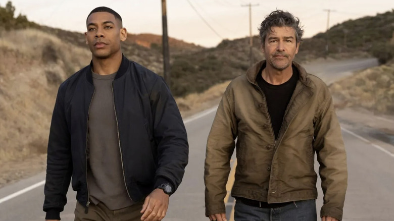 John Stewart and Hal Jordan walk along a highway in "Lanterns" (2026)