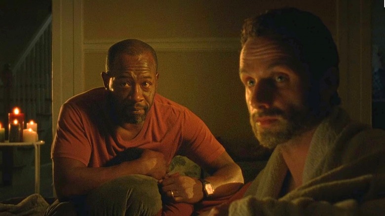 Morgan and Rick huddled by candlelight