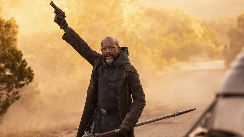 Morgan holding a gun in the air