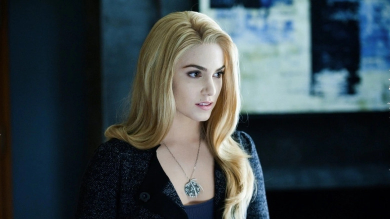 Rosalie standing and looking off to the side