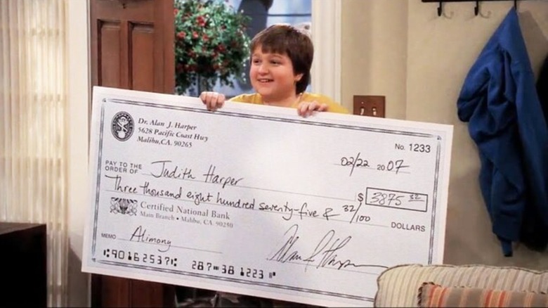 Jake holding a giant cheque