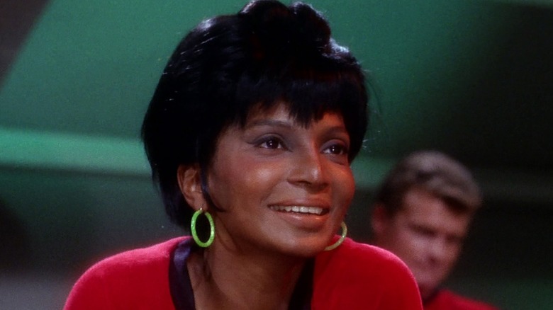 Uhura smiles in the Enterprise rec room in Star Trek: The Original Series  (1966 - 1969)