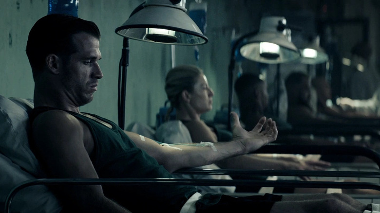 Test subjects hold out their arms