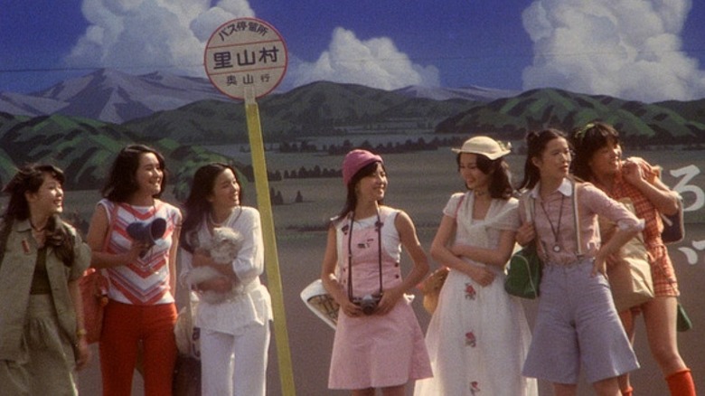 Girls smile at bus stop