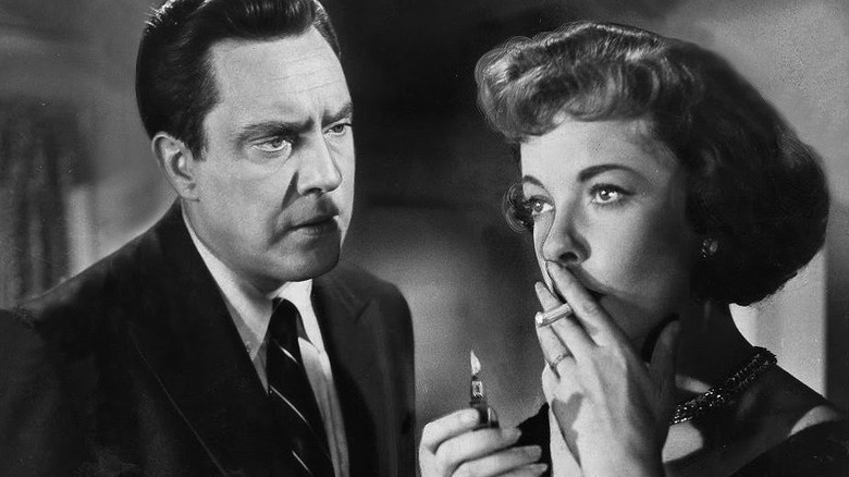 Ida Lupino lights a cigarette
