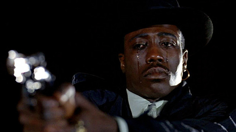 Wesley Snipes holding gun and crying