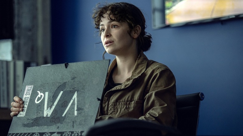 Vic McQueen opening a book in NOS4A2