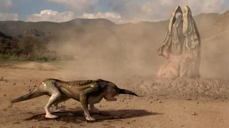 Project 4-12 standing in front of the Graboid in Tremors (2003)