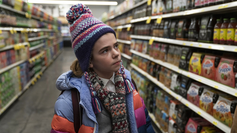 Young Kirsten stands in empty grocery store