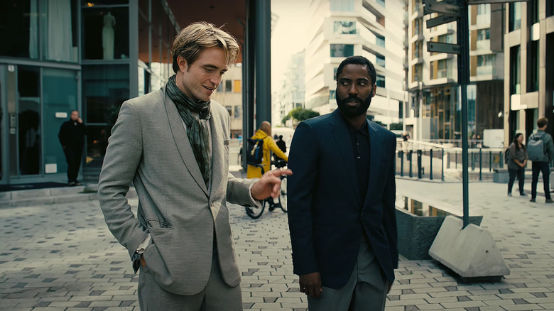 Neil and the protagonist walk through the street