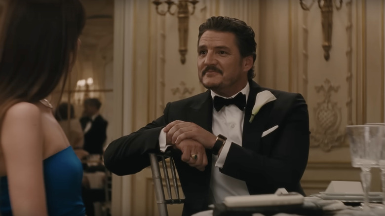 Harry sits looking at Lucy at a wedding dinner in "Materialists" (2025)