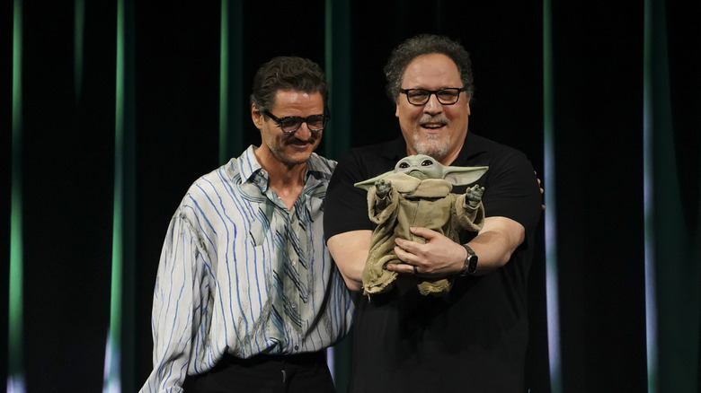Pedro Pascal and Jon Favreau with the Grogu puppet at Star Wars Celebration