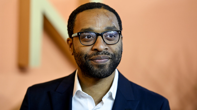 Chiwetel Ejiofor wearing glasses and navy blue suit